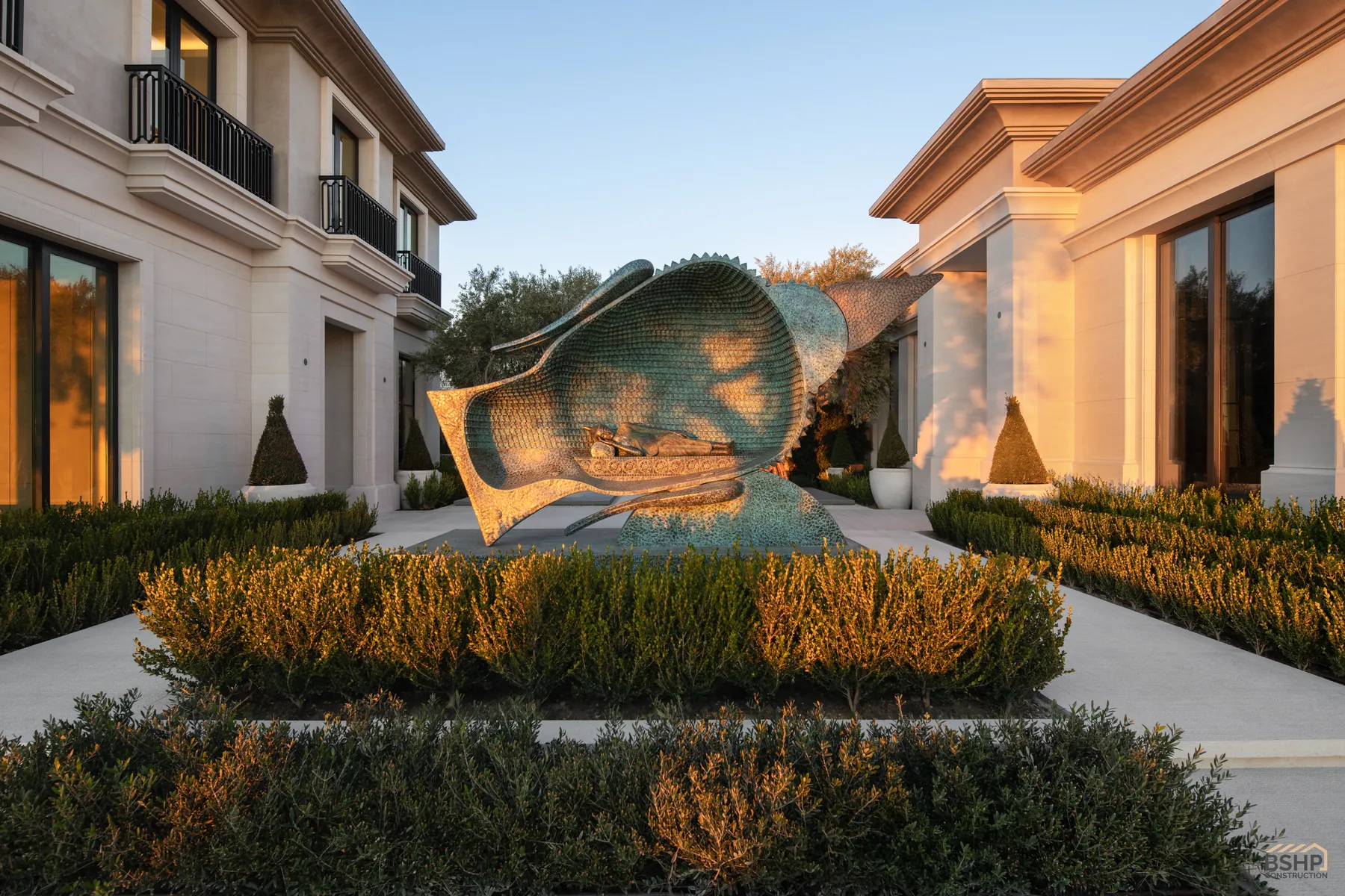 Monumental bronze sculpture in the garden court at dusk