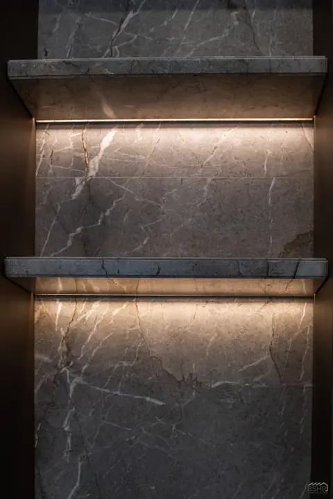 Backlit stone shelves with concealed LED coves
