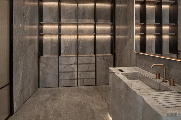 Backlit stone shelving niche with concealed linear lighting