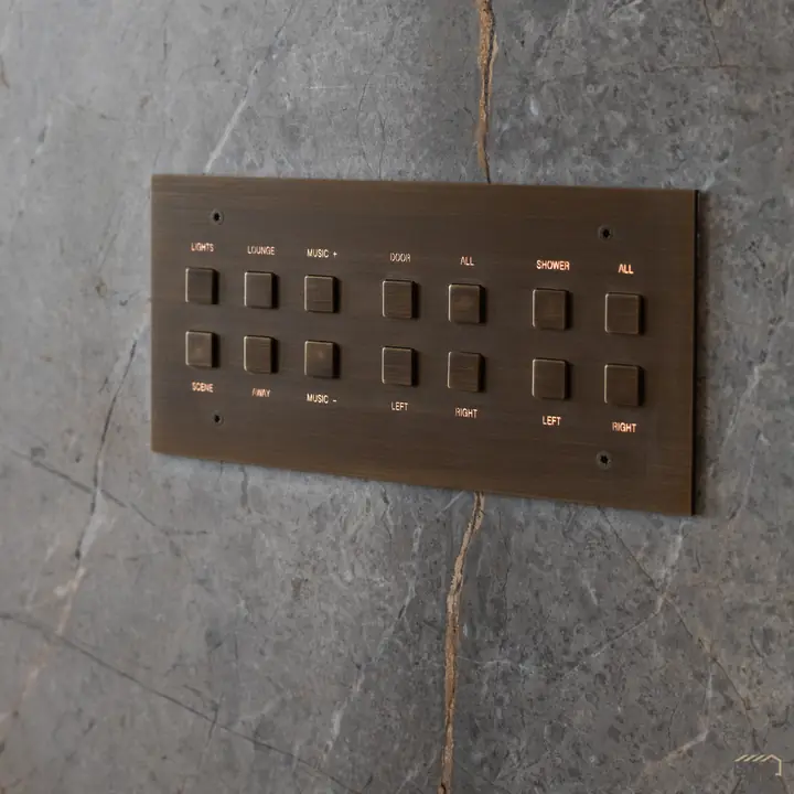 Custom bronze lighting control keypad on stone