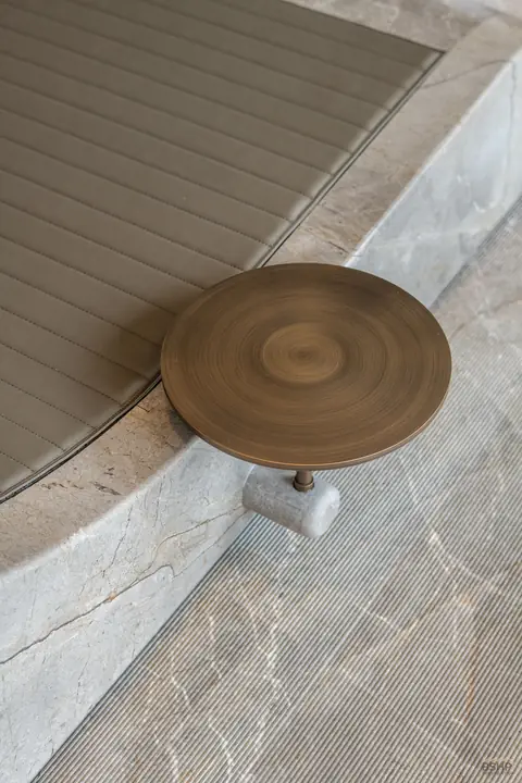 Machined bronze drain cap set flush into stone