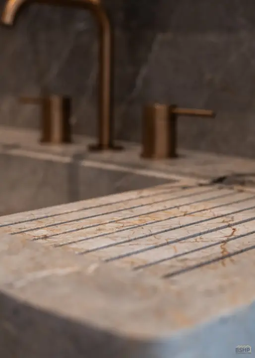 Bronze fittings with a carved stone drainboard