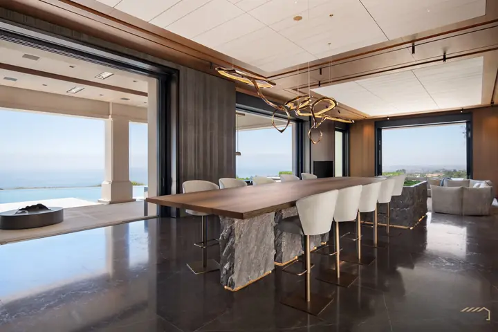 Dining room with a timber table on a carved stone base