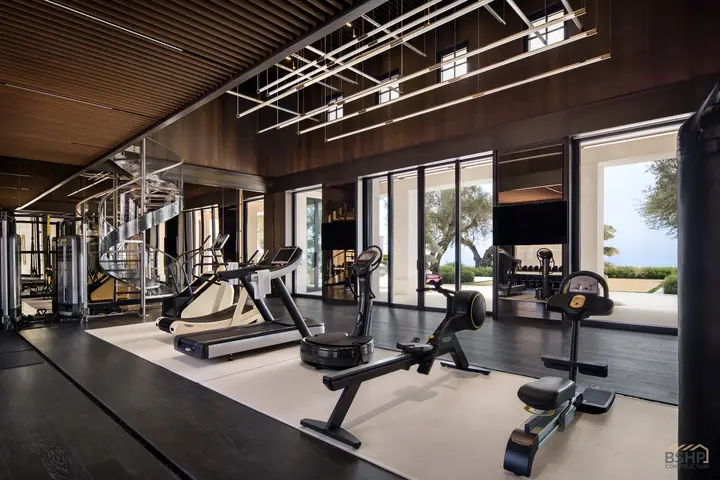 Cardio equipment facing the ocean view from the fitness suite
