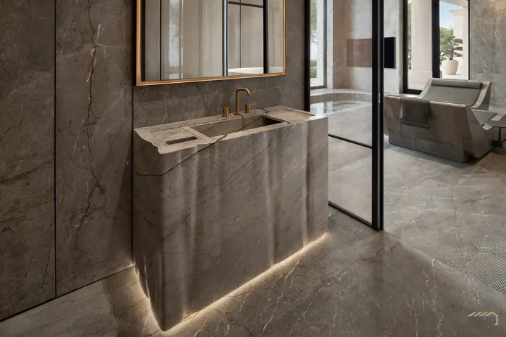 Floating stone vanity with integrated basin and bronze fittings