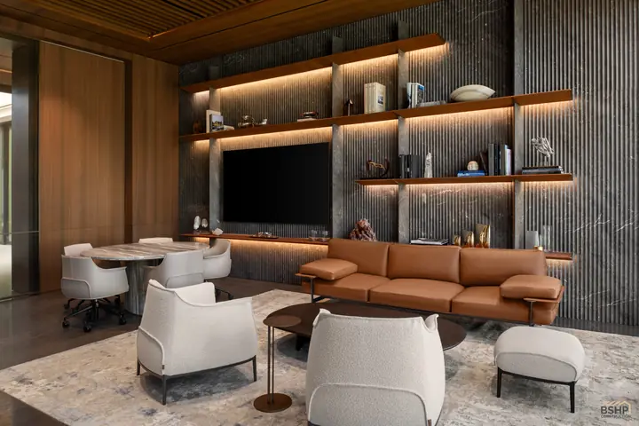 Home office lounge seating against the shelved media wall in stone and timber
