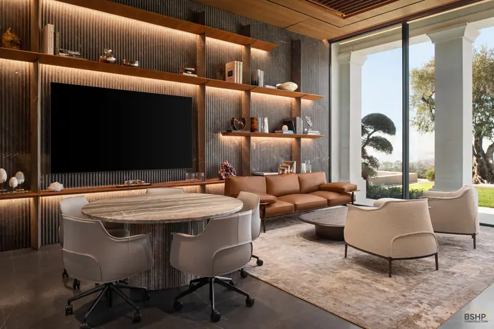 Home office with a full-width shelved wall, integrated media and a cognac leather sofa