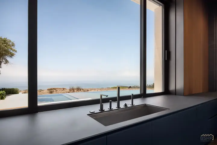 Kitchen window and bronze fittings overlooking the Pacific