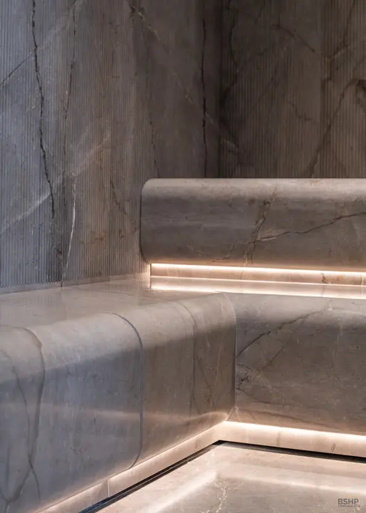 Solid marble bench with a continuous cove light