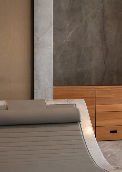 Spa pool edge with teak cabinetry beyond