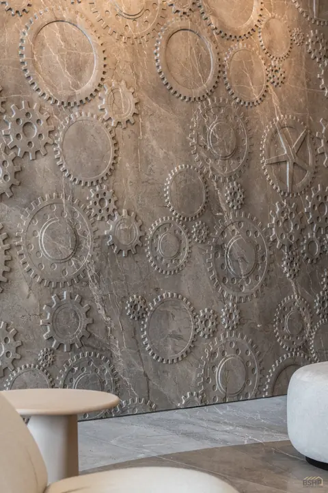 Sculpted relief wall with a carved stone side table