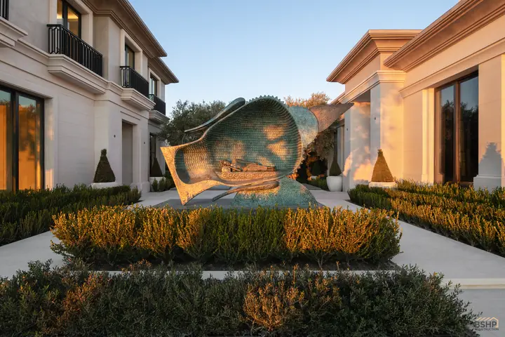 Monumental bronze sculpture in the garden court at dusk