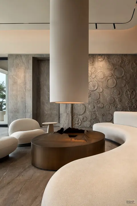 Spa lounge seating around a polished bronze fire bowl
