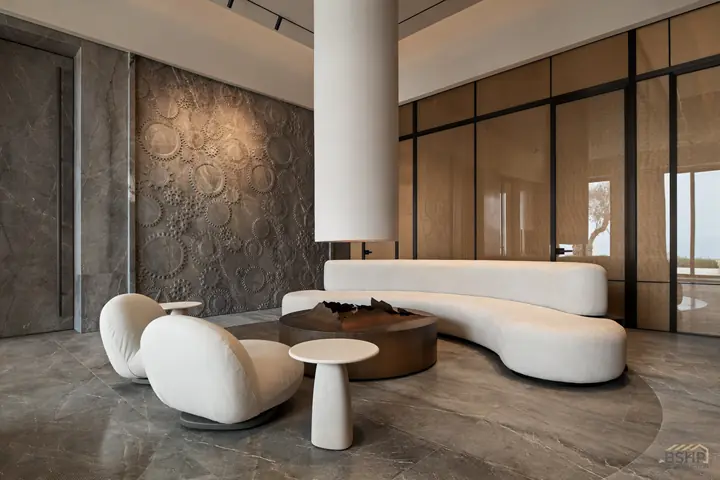 Carved stone wall with custom furniture, mixture of stone, fabric, brass and plaster. Custom brass fireplace