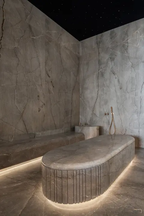 Carved stone bench beneath a fibre-optic starlit ceiling